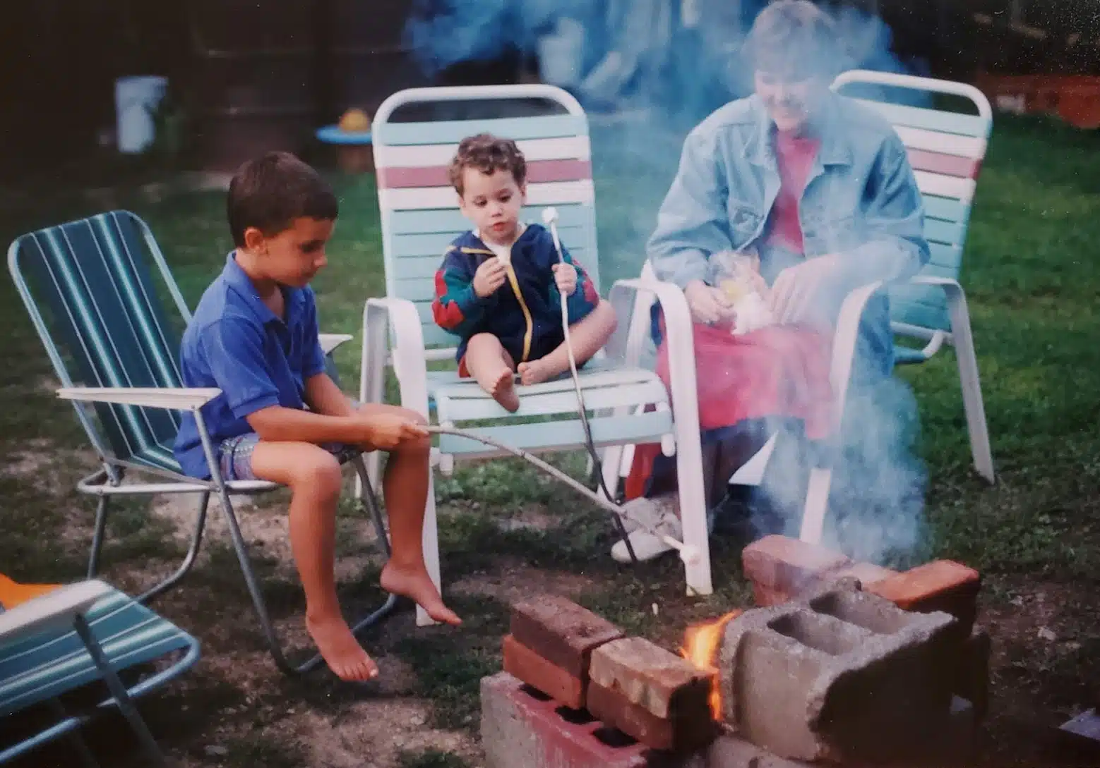 Nicole Lorber, Owner of Distinctive Interior Designs in Marlton, New Jersey, family Scrapbook showing her kids at campfire with Grandma