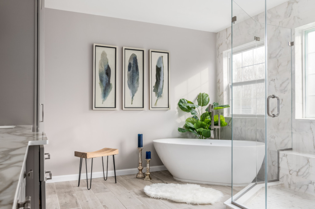 Freestanding tub, custom shower, tile wall with art