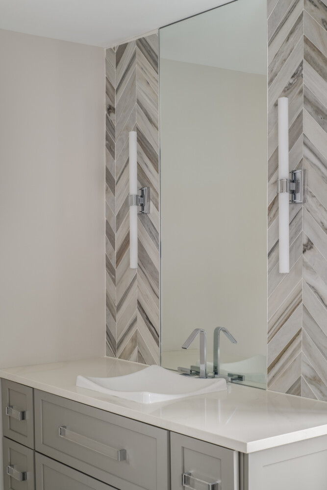 Close up of modern main bathroom vanity herringbone tile