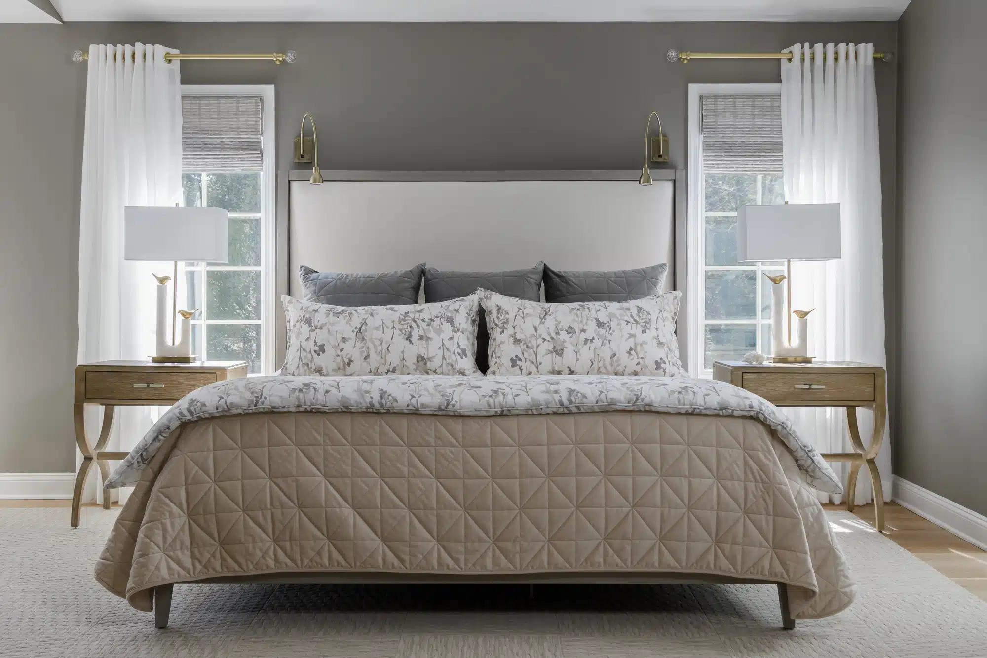 Spa like master bedroom with custom bedding and wall color tones in cream, tan, grays, with short-napped velvet euros and suble floral, with flor.com basket weave floor tile area rug in Medford, New Jersey