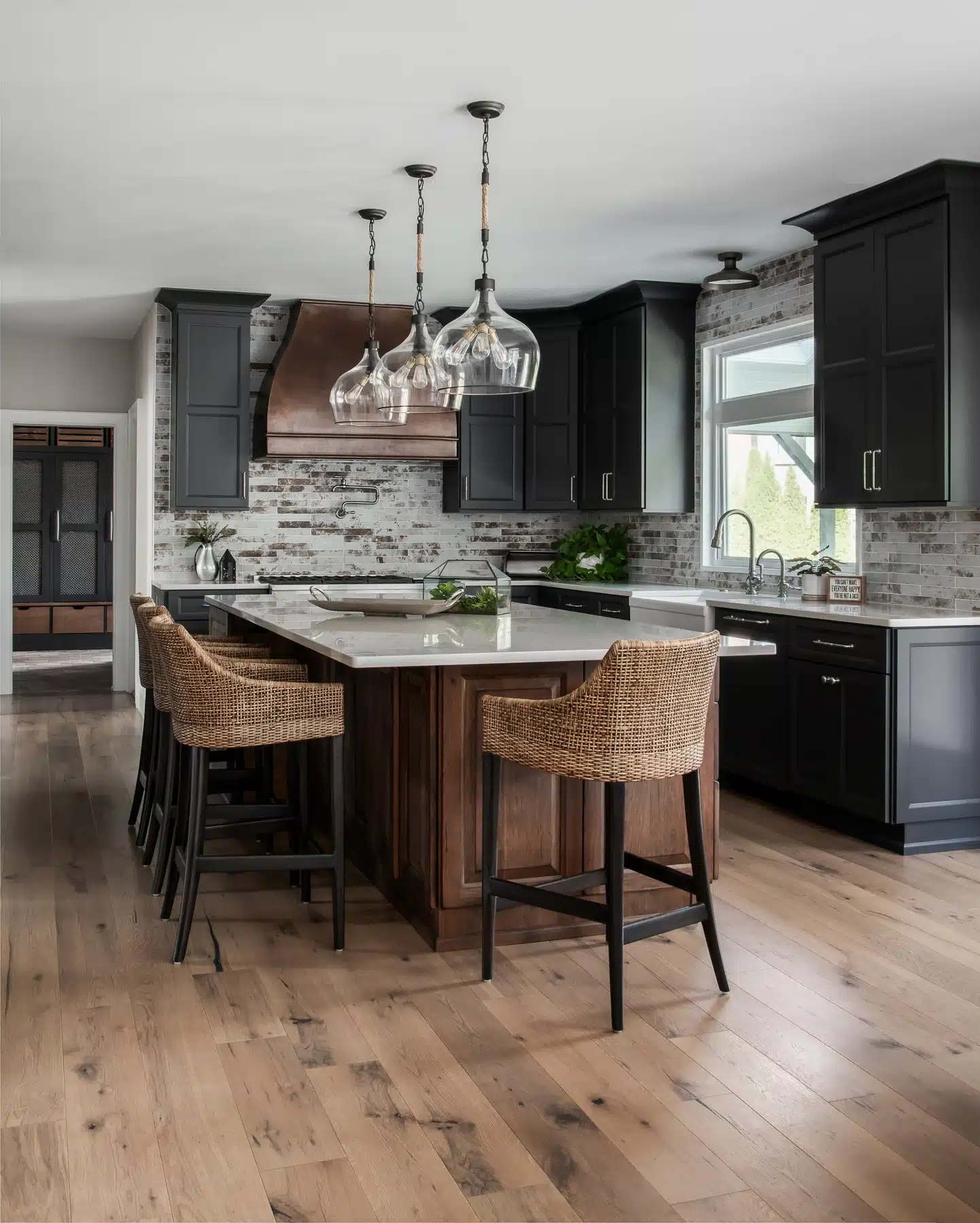 Newly renovated moody Industrial farmhouse kitchen renovation, dark gray and distressed walnut cabinets, brick tile backsplash in Moorestown, New Jersey