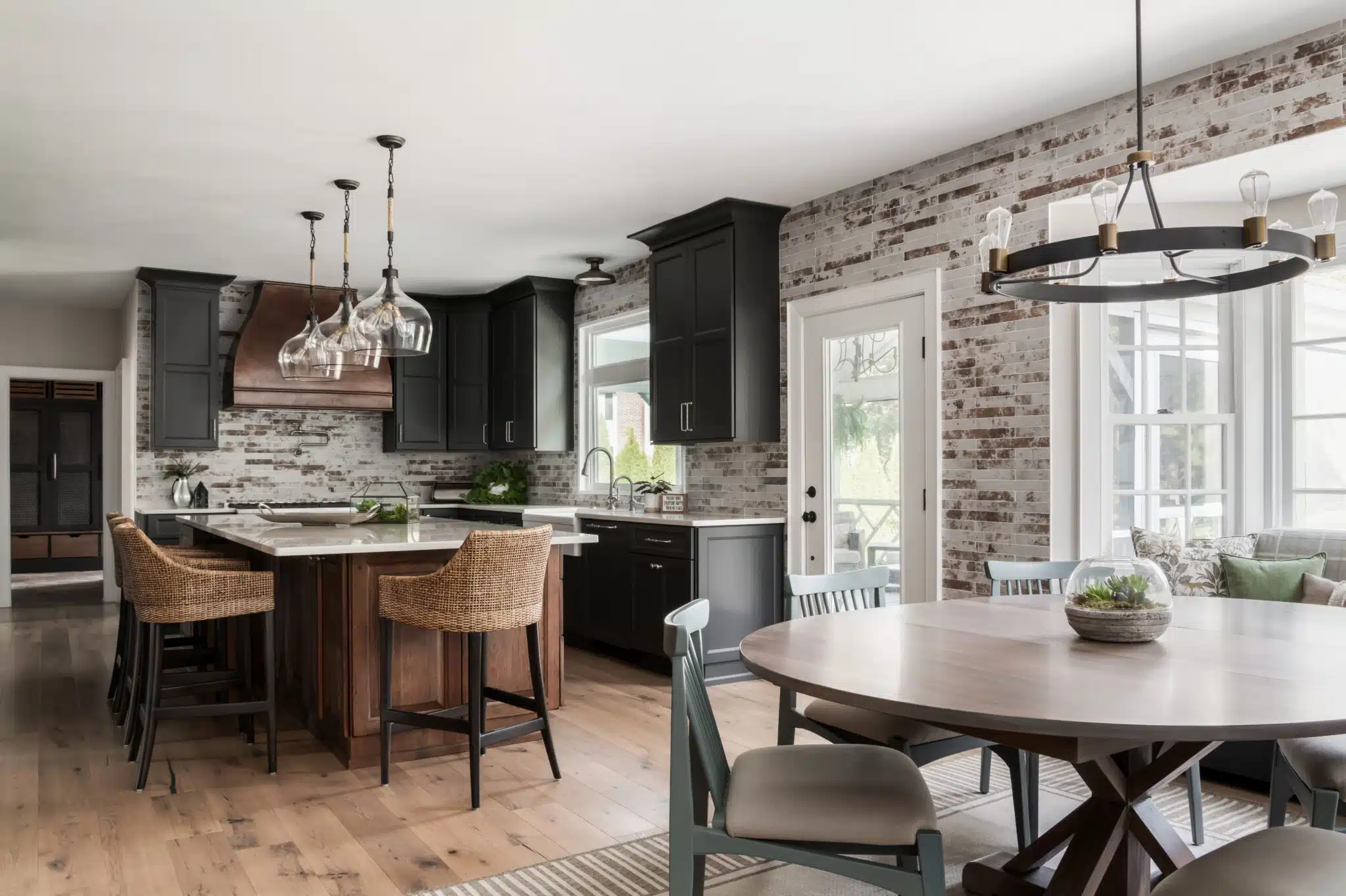 Newly renovated moody Industrial farmhouse kitchen renovation, dark gray and distressed walnut cabinets, brick tile backsplash in Moorestown, New Jersey