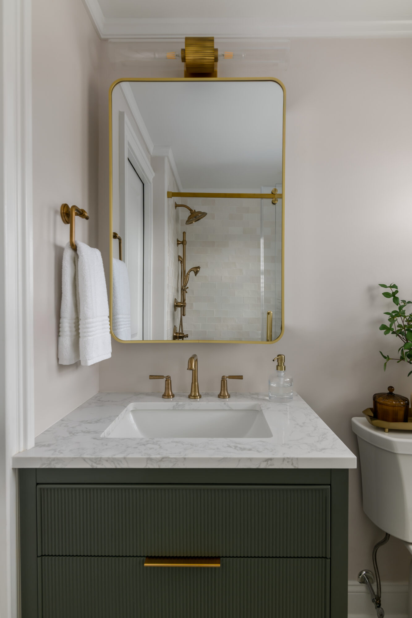 Marlton, New Jersey, modernized primary bathroom after renovation with green ribbed vanity and matte gold acct