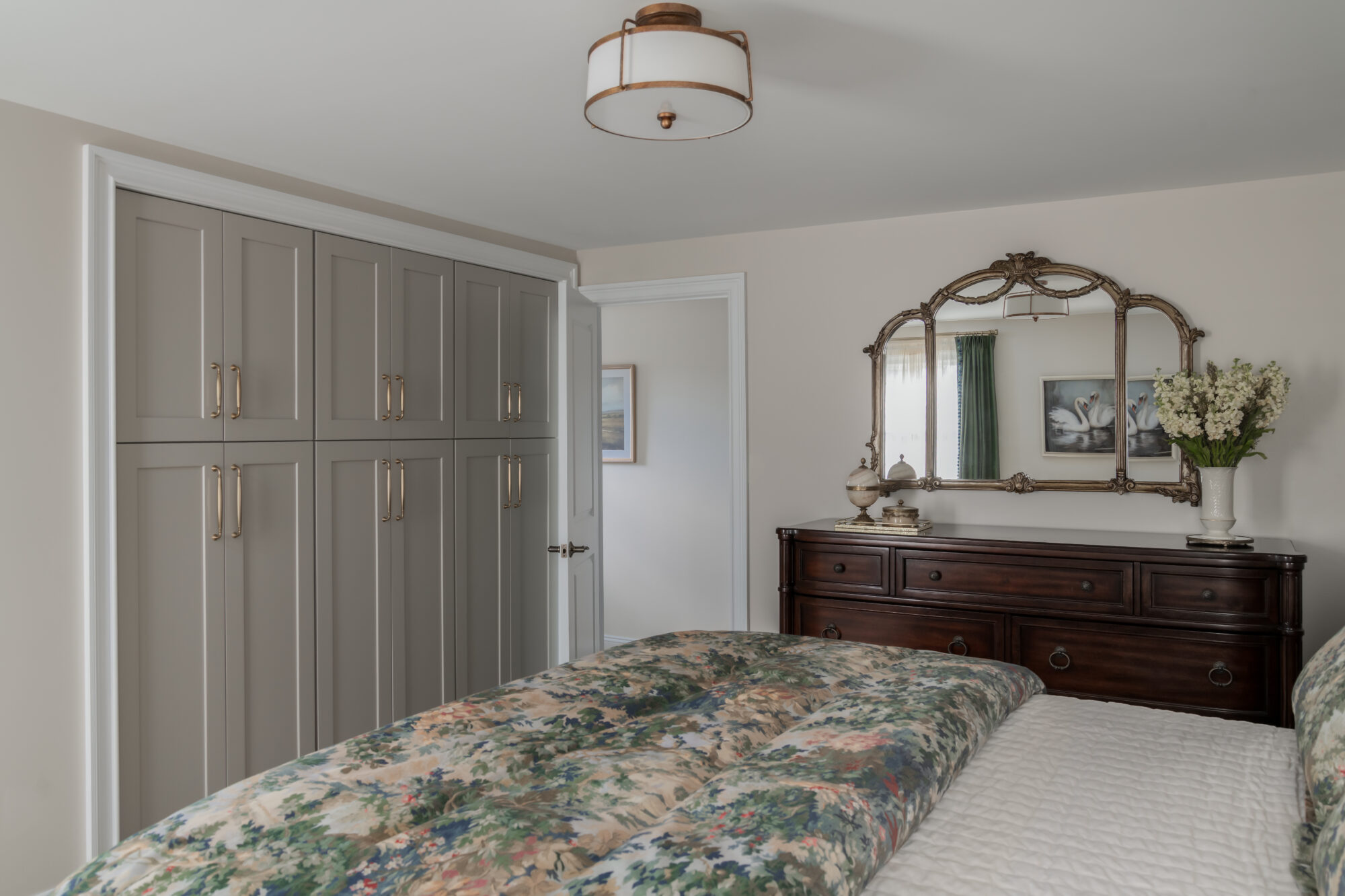 Marlton, New Jersey, primary bedroom with blue toile bedding, custom wardrobe, and old world gold mirror