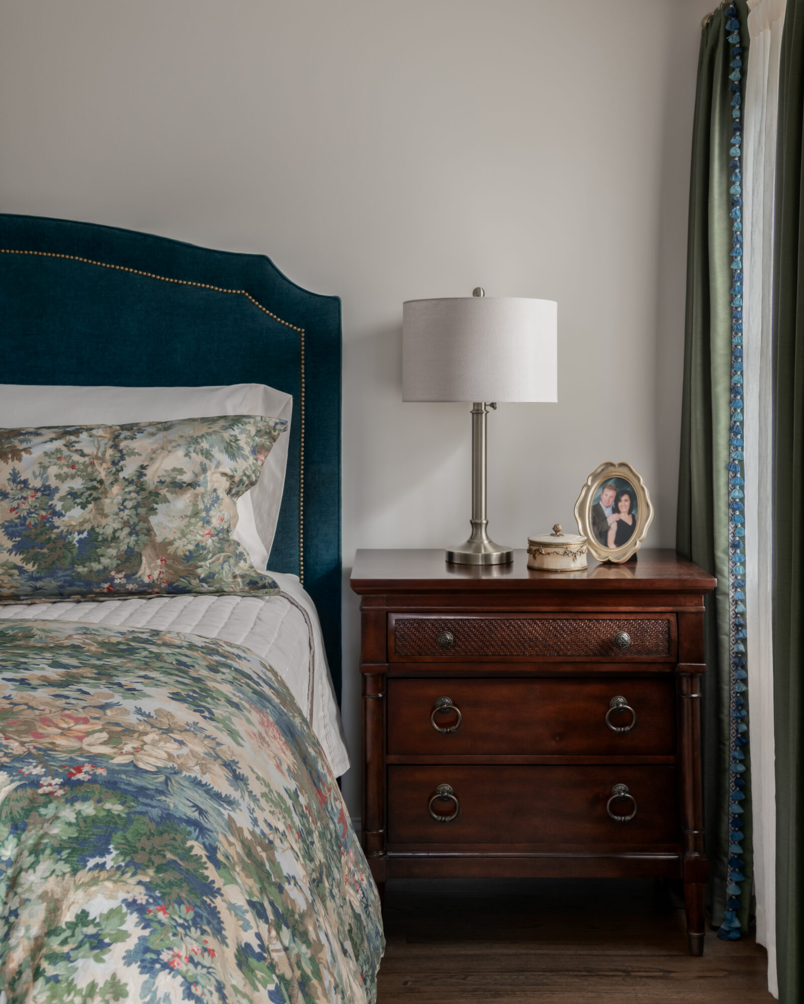 Marlton, New Jersey, primary bedroom with blue toile bedding, teal velvet headboard and Hooker Furniture table