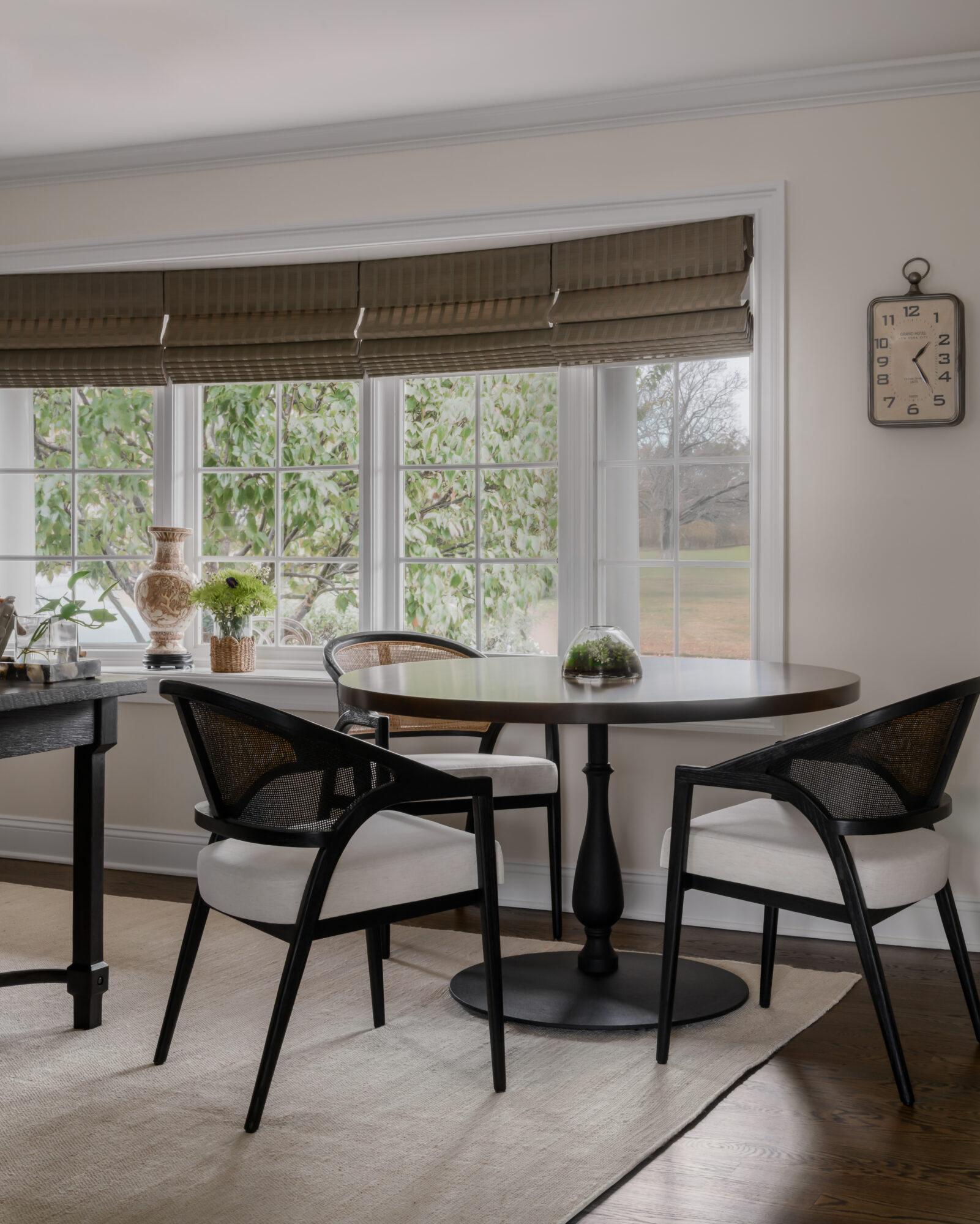 Office with custom pedestal table and Arhaus aimee chairs with Woven Roman shades in Marlton, New Jersey