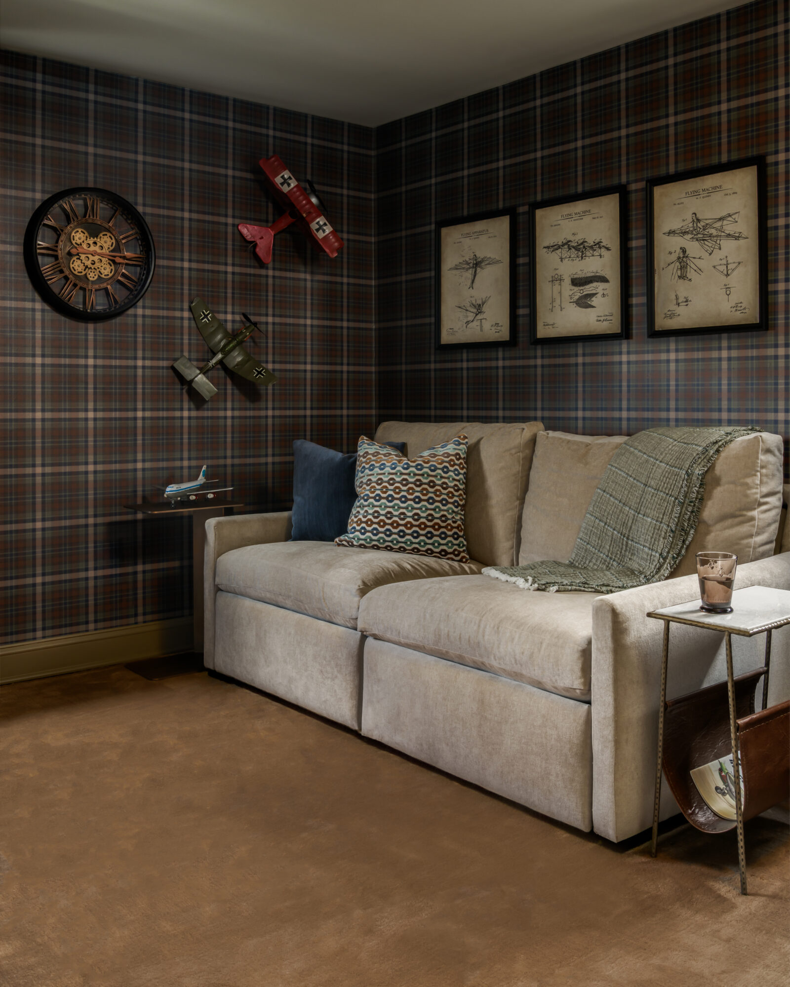 Steampunk den with Arhaus motorized recliner, dark plaid wallpaper, and cool details in Marlton, New Jersey