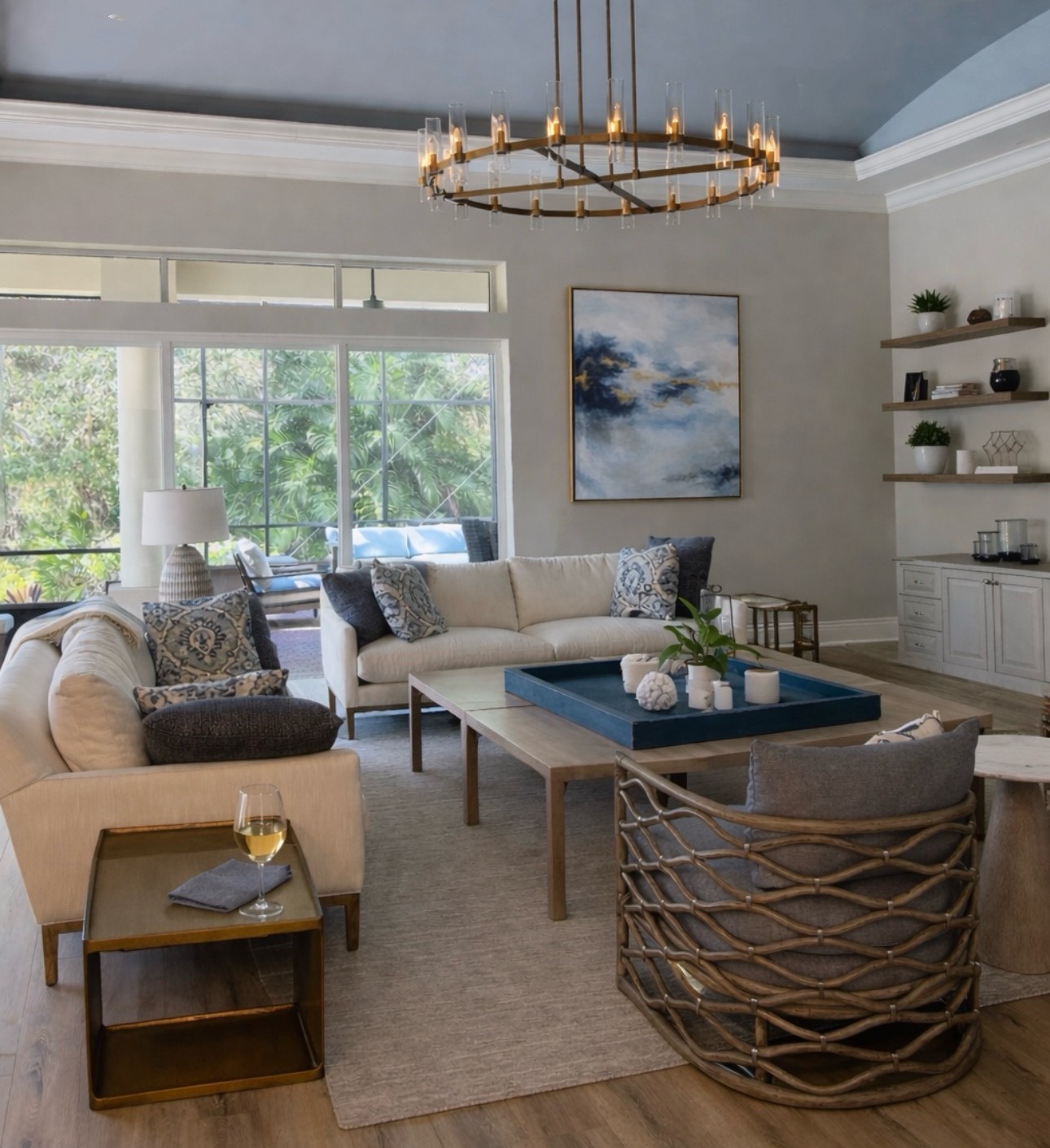 Coastal-living-room-with-neutral-furnishings-large-windows-and-indoor-outdoor-in-Estero-Florida